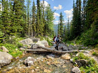 Clayton crossing the outlet creek of Scarab Lake